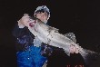 A picture in which I hold a seabass of 87 cm in length and 5.4 Kg in weight.